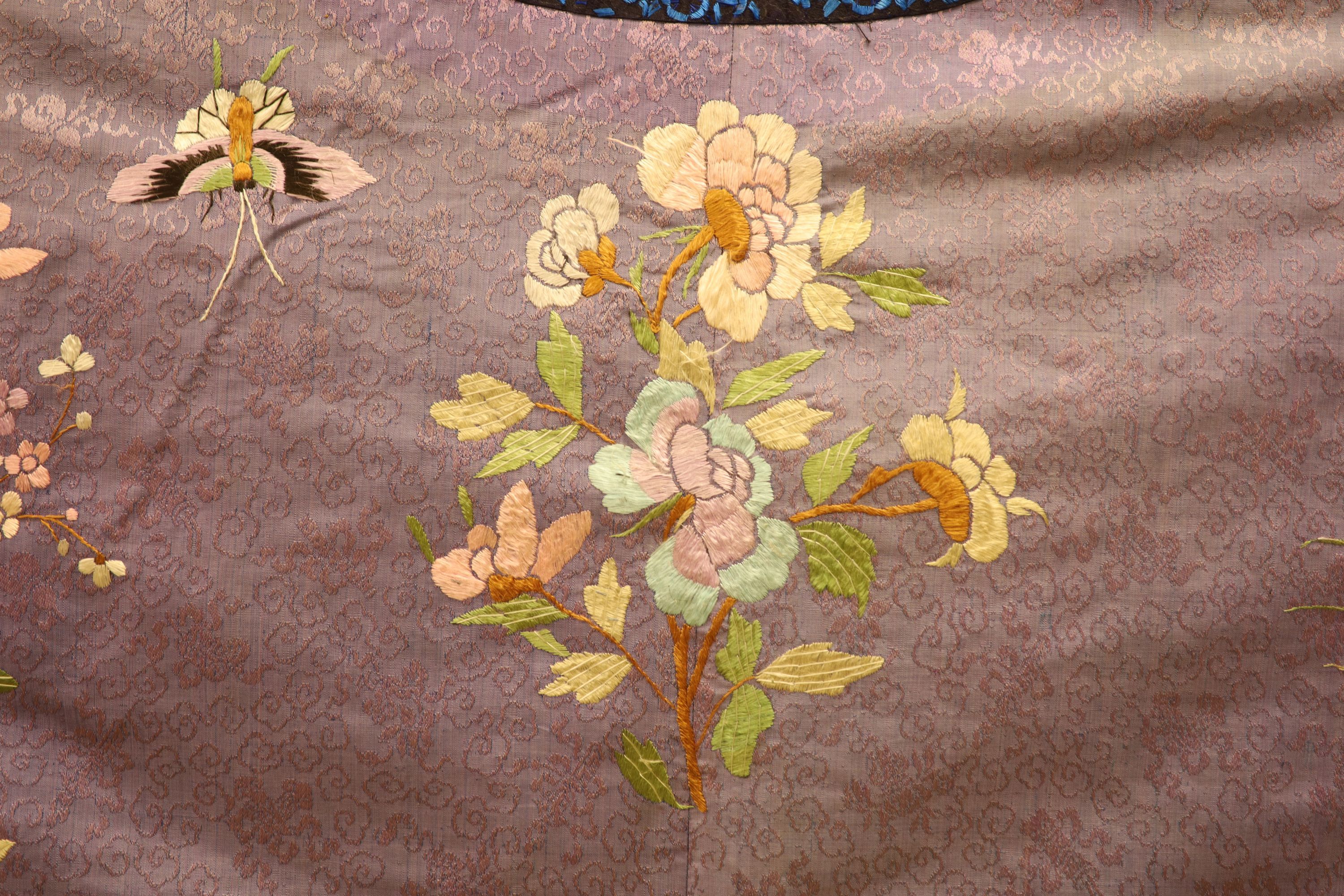 A Chinese lilac silk embroidered robe, early 20th century with multi-coloured embroidery and wide embroidered sleeve bands,